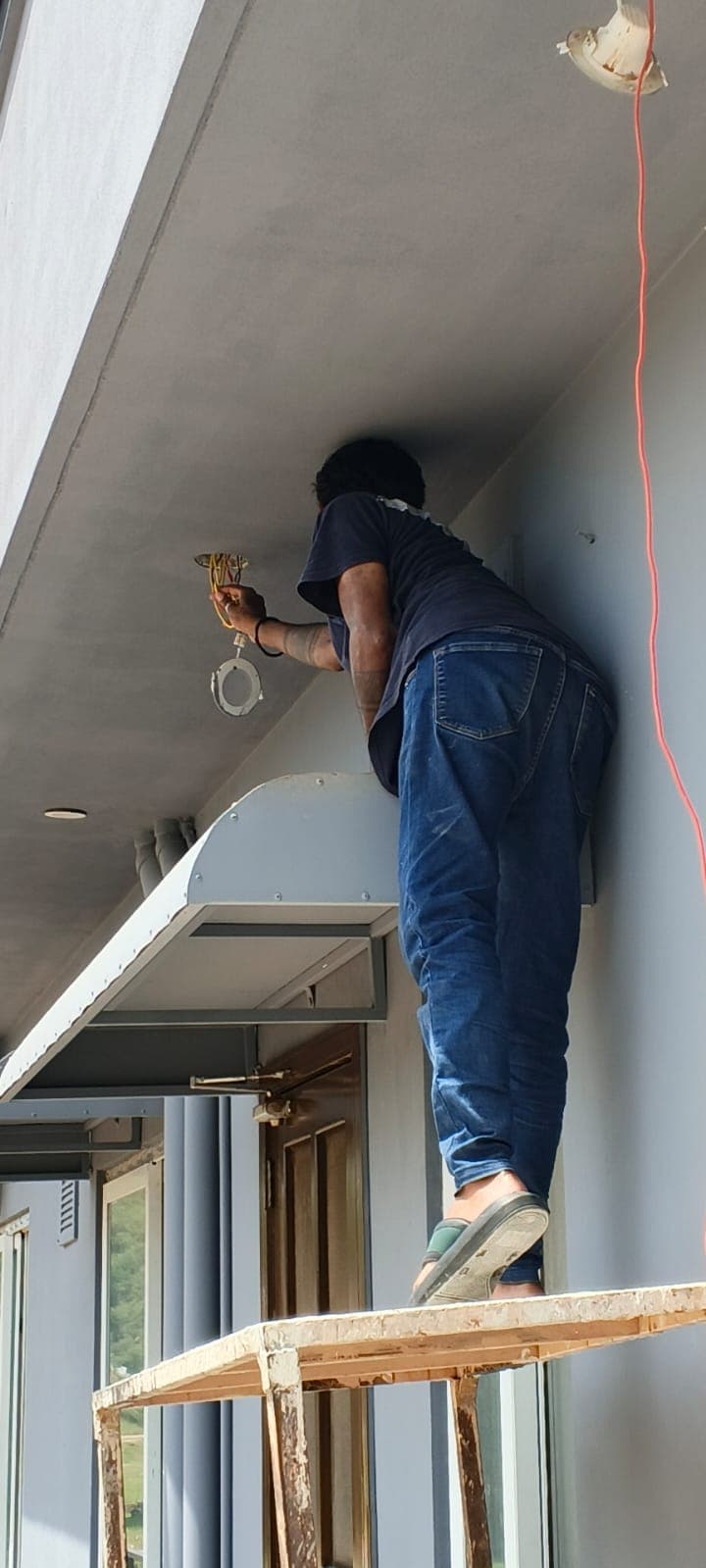 Technician preparing a CCTV camera installation point